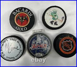 Hockey Puck collection set of 5 pucks autographed hockey puck Mike Eruzioe plus